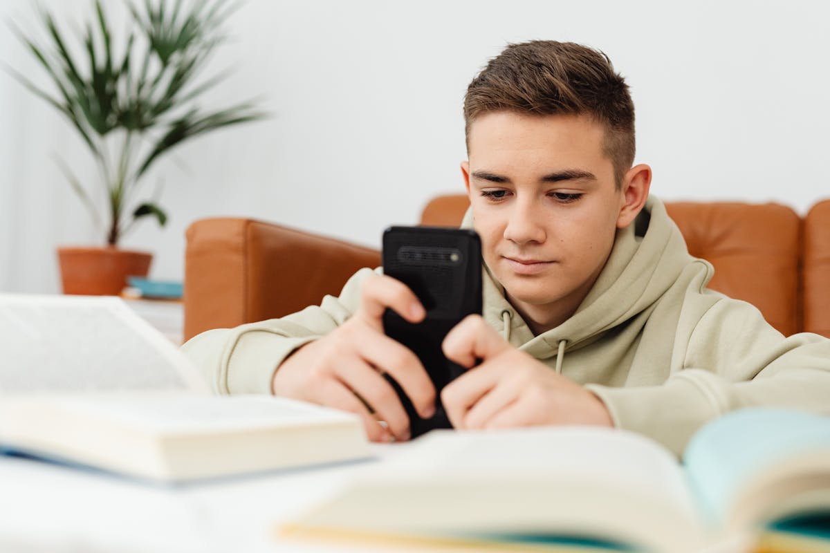 A guy looking at his smartphone — the new Šaunuolė mobile experience in users' hands